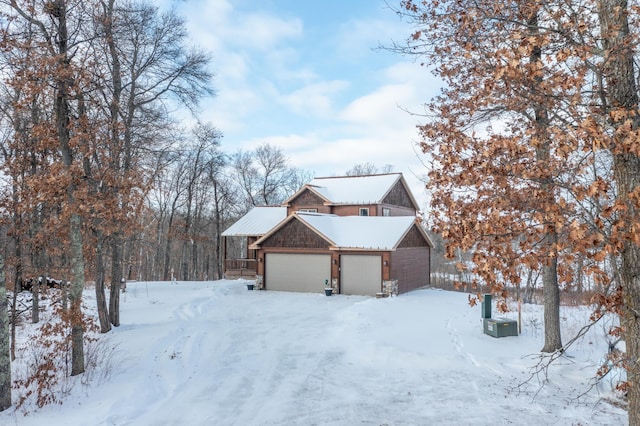 view of snowy exterior with a garage