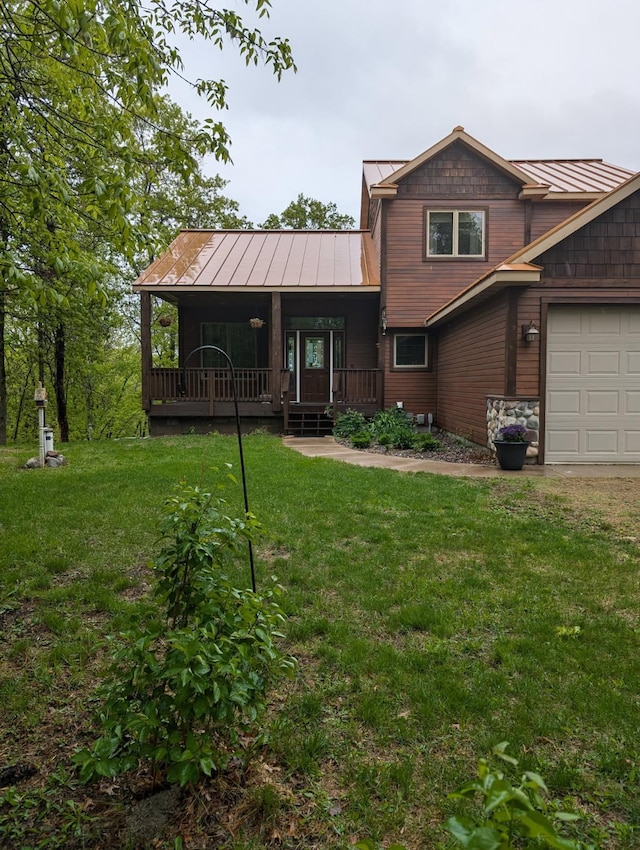 9414 Beverly Dr, Breezy Point, MN 56472 - view of front of home with a standing seam roof, covered porch, a front yard, and an attached garage