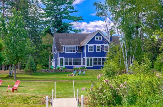 back of house featuring a yard