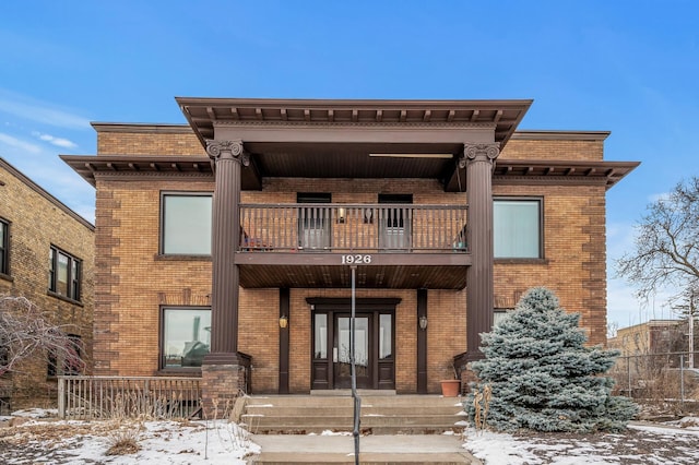 view of front of house with a balcony and covered porch