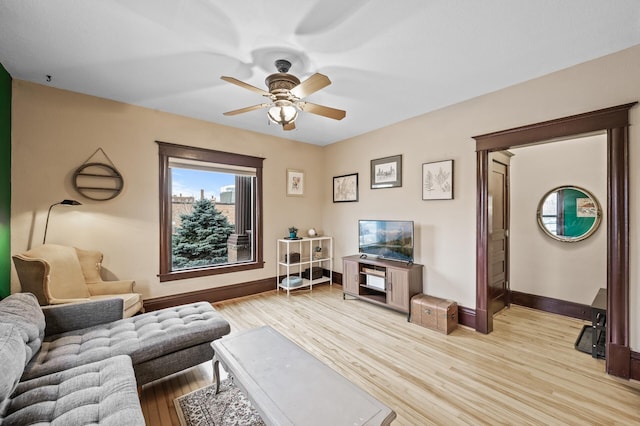 living room featuring ceiling fan and light wood-type flooring