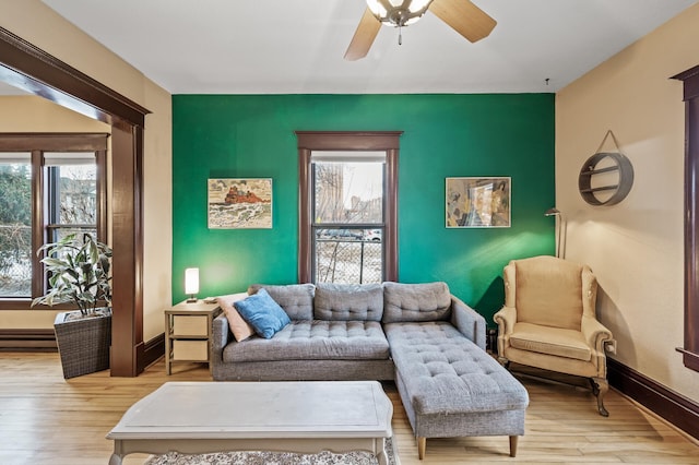 living room featuring ceiling fan and light hardwood / wood-style flooring