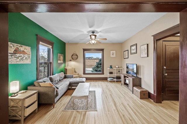 living room with ceiling fan, light hardwood / wood-style flooring, and a wealth of natural light