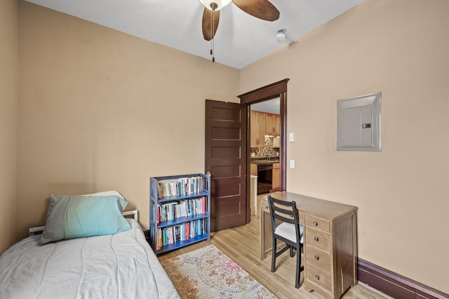 bedroom with ceiling fan, electric panel, and light hardwood / wood-style floors