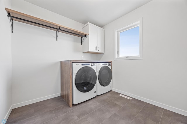 washroom featuring cabinets and separate washer and dryer