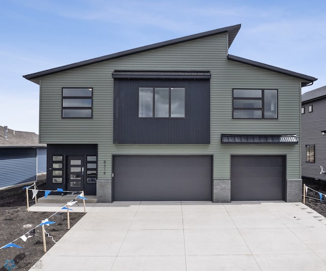 view of front facade featuring an attached garage, brick siding, and concrete driveway