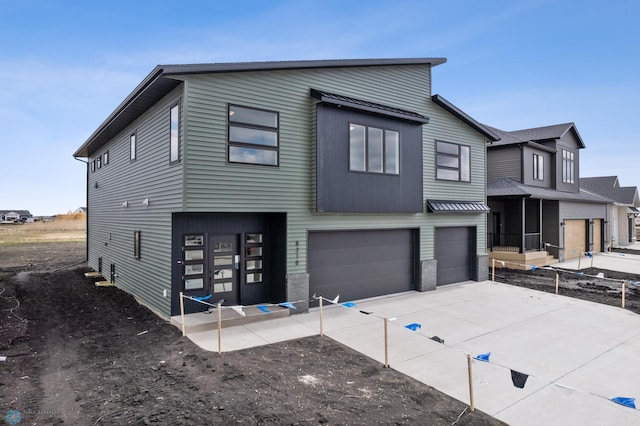 contemporary home featuring a garage and concrete driveway