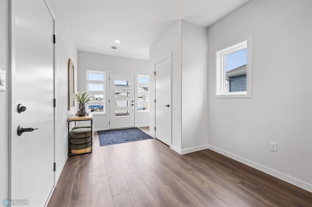 entryway with recessed lighting, baseboards, and dark wood-style flooring