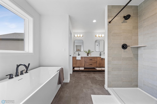 bathroom featuring vanity, tile patterned flooring, a freestanding bath, and tiled shower