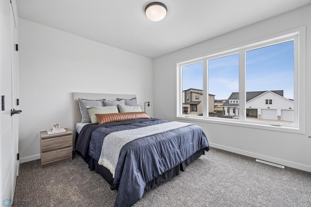bedroom featuring baseboards and carpet flooring