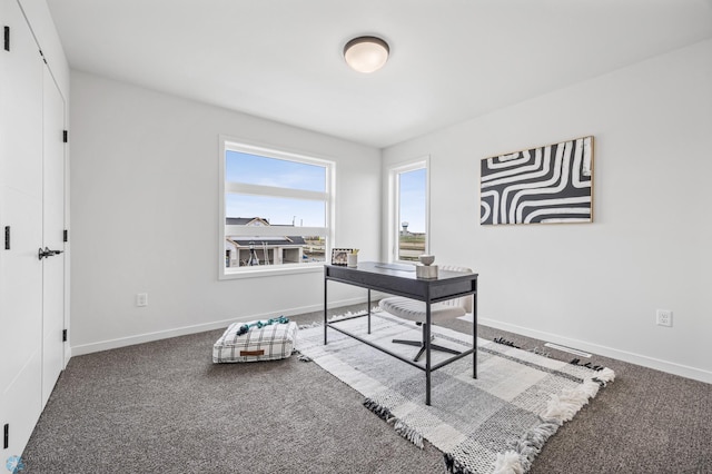 carpeted home office featuring baseboards