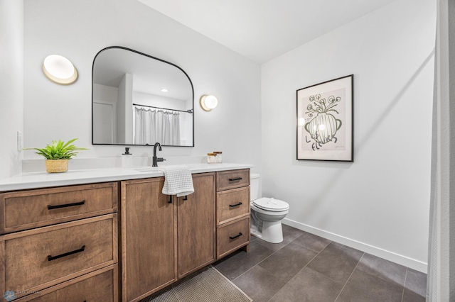 full bath with baseboards, tile patterned floors, toilet, and vanity