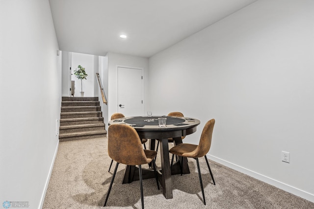 carpeted dining space with recessed lighting, baseboards, and stairway