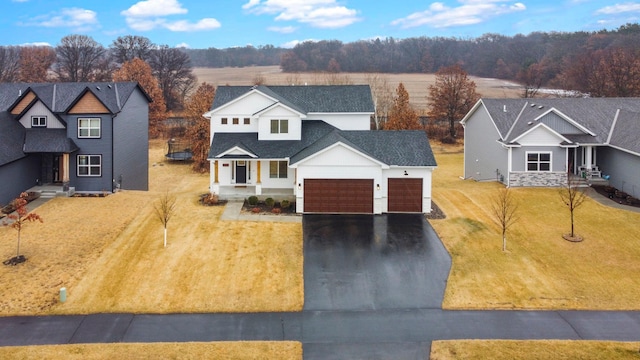 view of front of house with aphalt driveway, a front yard, a shingled roof, and a garage