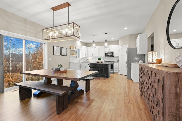 dining area featuring light wood finished floors and recessed lighting