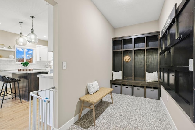 mudroom with light wood-style flooring and baseboards