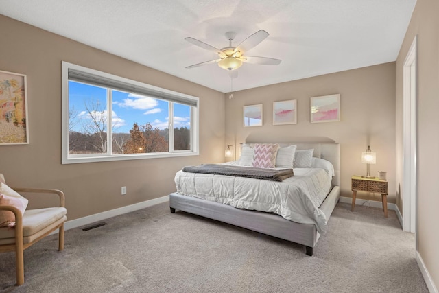 carpeted bedroom featuring ceiling fan, visible vents, and baseboards