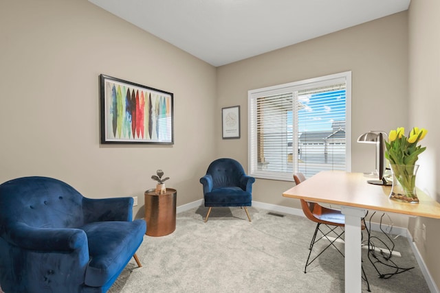 carpeted office space featuring visible vents and baseboards