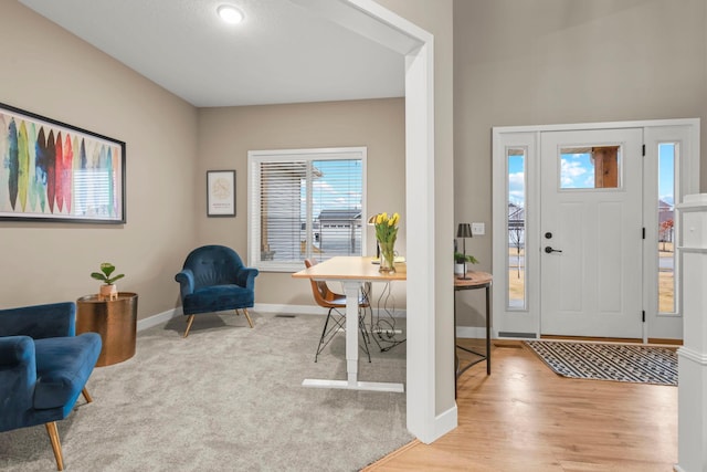 foyer featuring light wood-style floors and baseboards