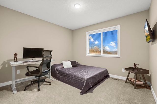 carpeted bedroom with visible vents and baseboards