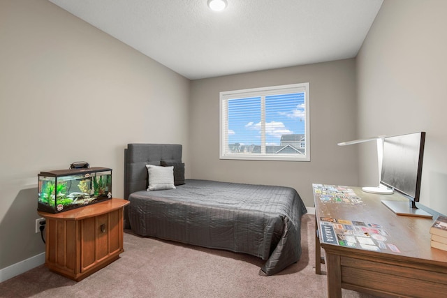 bedroom with light carpet and baseboards