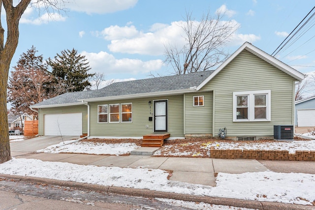 single story home featuring a garage and central AC