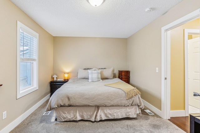 carpeted bedroom with a textured ceiling