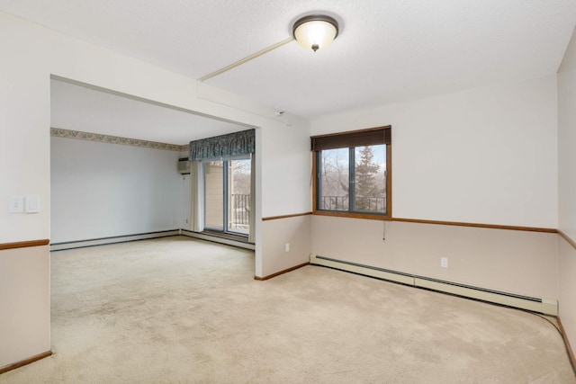 unfurnished room featuring light colored carpet, a textured ceiling, and baseboard heating