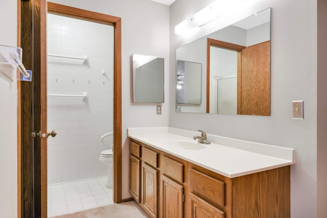 bathroom featuring vanity, toilet, an enclosed shower, and tile patterned flooring