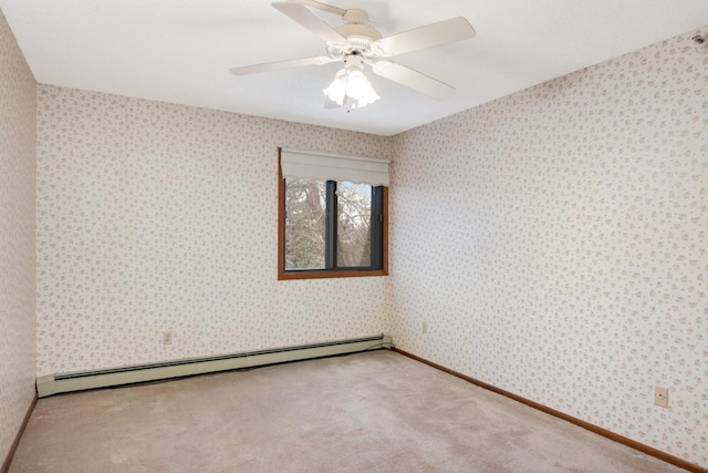 spare room with a baseboard heating unit, ceiling fan, and carpet flooring