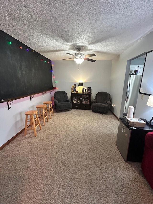 interior space featuring ceiling fan and a textured ceiling