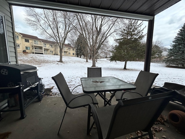 snow covered patio with grilling area