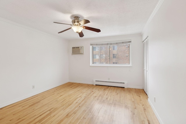 unfurnished room with crown molding, light wood-type flooring, a textured ceiling, and baseboard heating