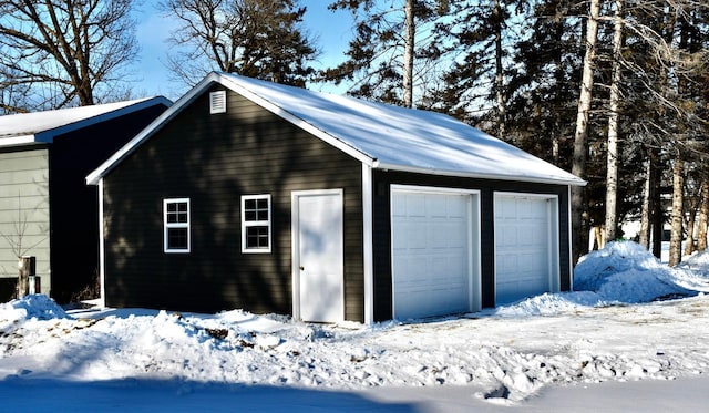 view of snow covered garage