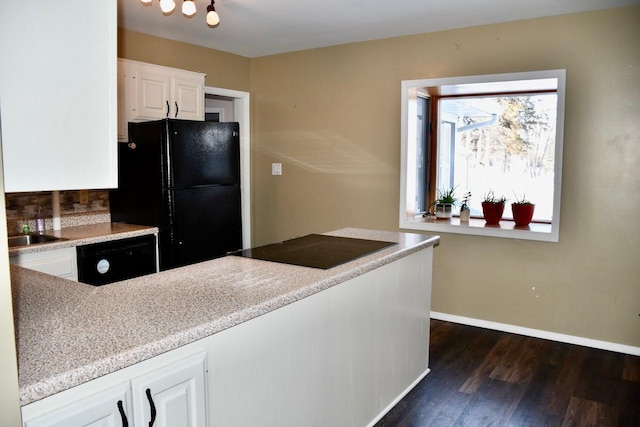 kitchen with white cabinetry, black appliances, and dark hardwood / wood-style floors