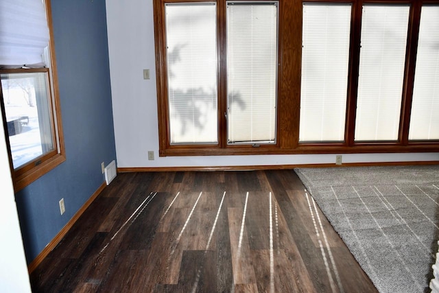 empty room with dark wood-type flooring