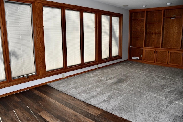 spare room featuring dark wood-type flooring