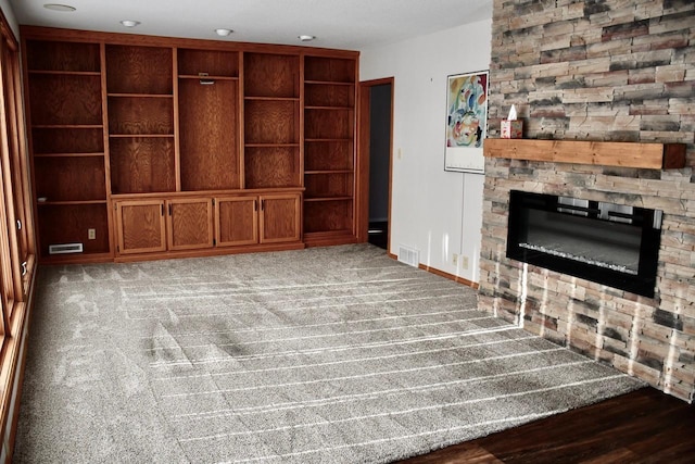 unfurnished living room with light colored carpet and a fireplace