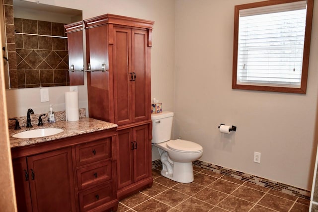 bathroom with vanity, toilet, and tile patterned flooring