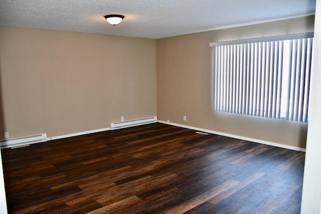 unfurnished room featuring a healthy amount of sunlight, dark wood-type flooring, a textured ceiling, and baseboard heating