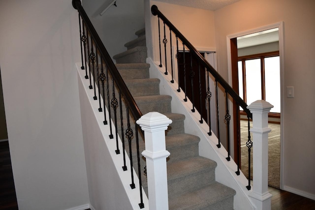 stairway with hardwood / wood-style floors