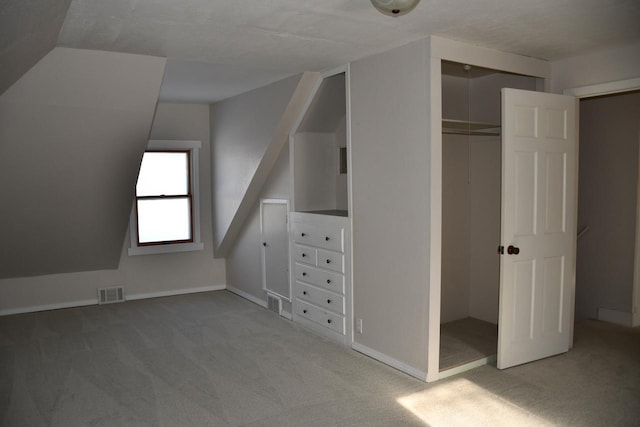 interior space featuring vaulted ceiling and carpet floors