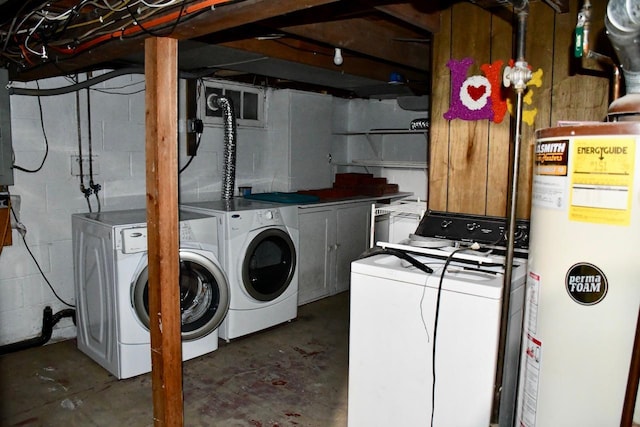 laundry area featuring washing machine and clothes dryer, electric panel, and gas water heater