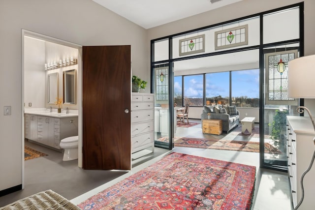 bedroom featuring sink and ensuite bath