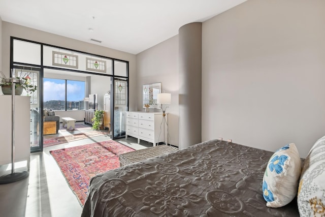 bedroom featuring concrete flooring