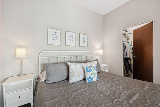 bedroom with a spacious closet and a closet