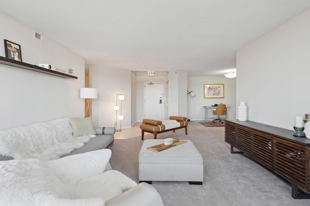 living room featuring light carpet and a textured ceiling