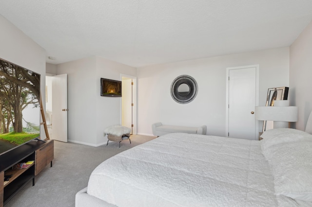 carpeted bedroom featuring a textured ceiling