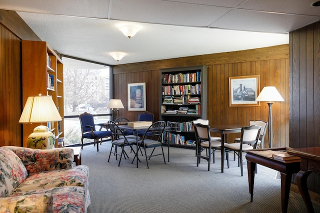 interior space featuring carpet floors and wood walls