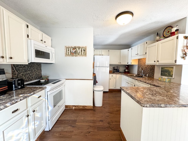 kitchen with a sink, white appliances, tasteful backsplash, and dark wood-style floors